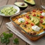 Taco Casserole baked with cheese, beef, beans, and toppings