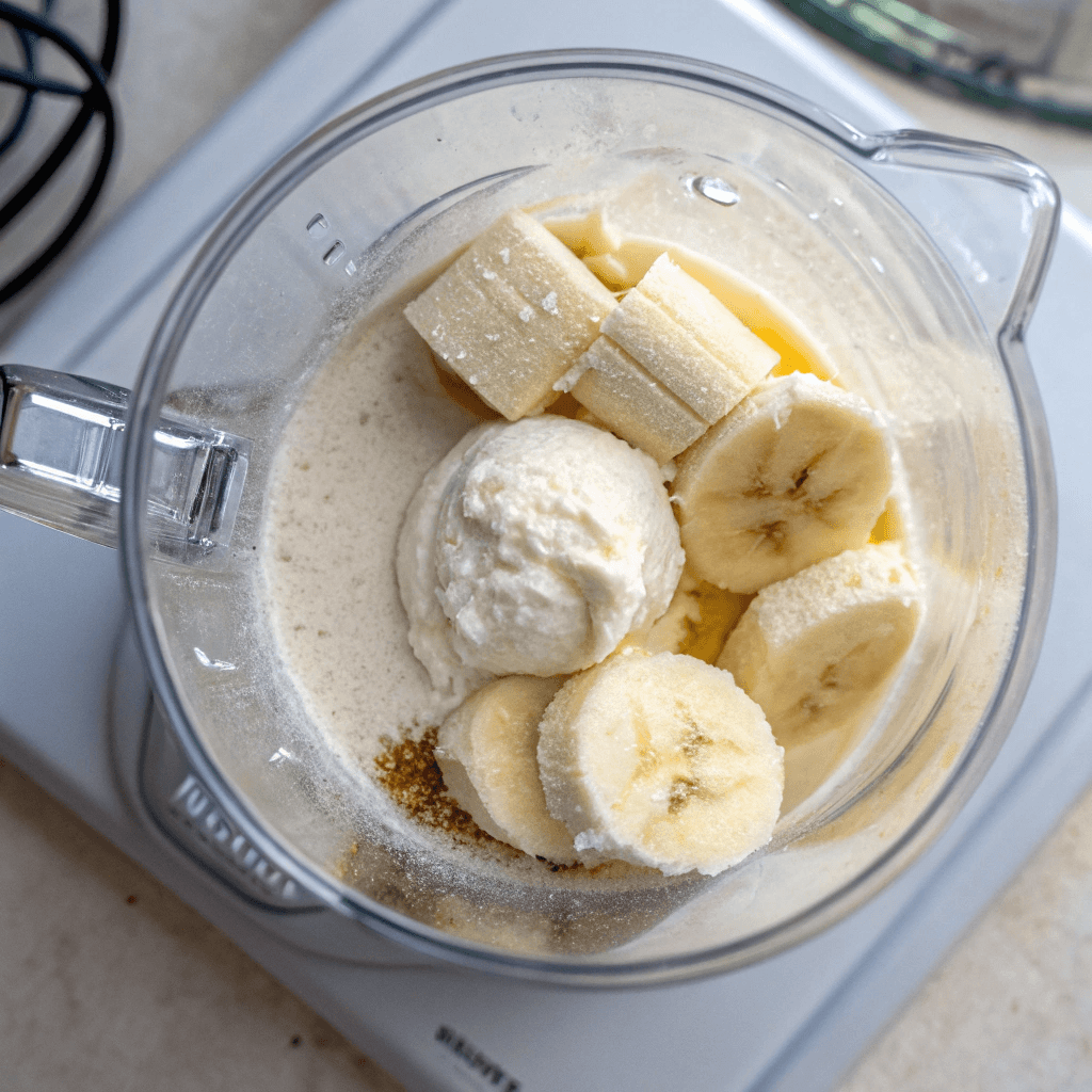 Blending Greek yogurt, banana, and protein powder