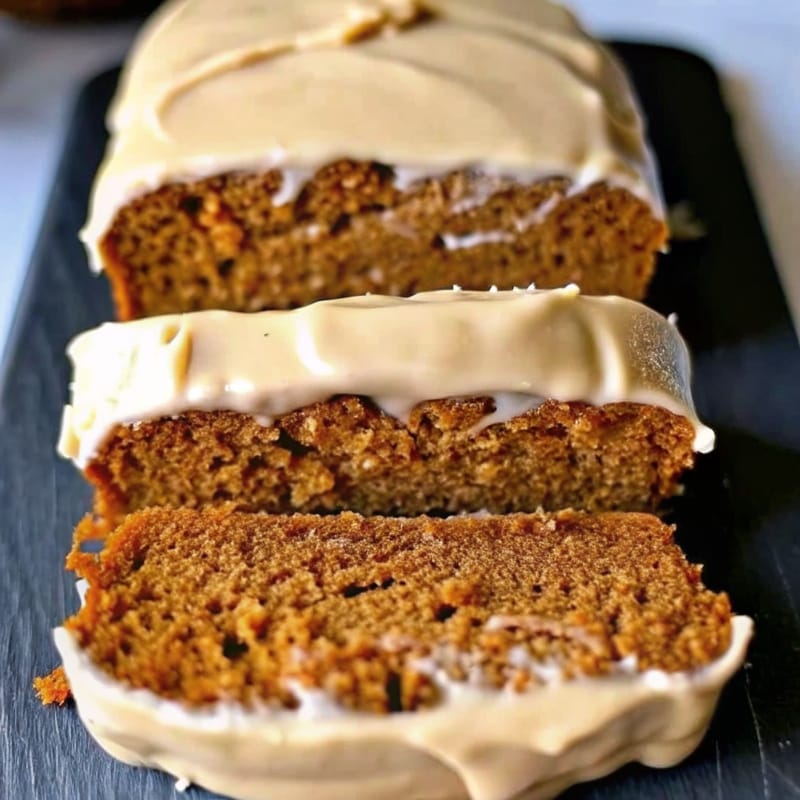 Healthier Pumpkin Banana Bread loaf sliced on rack