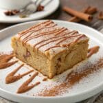 Slice of moist apple cake with cinnamon icing